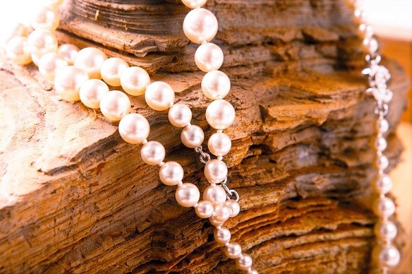 pearl pendant displayed on large rock